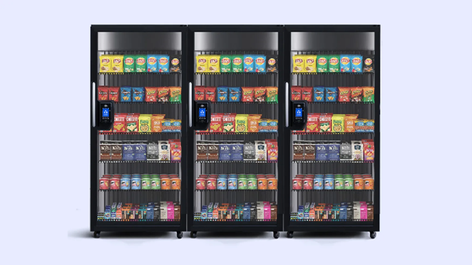 Three refrigerated vending machines stocked with various drinks and snacks.